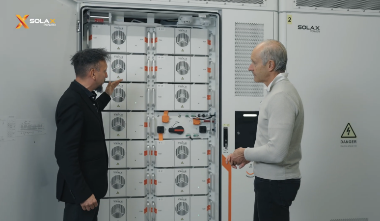Two technicians discussing SolaX energy storage system operation Two technicians discussing SolaX energy storage system operation
